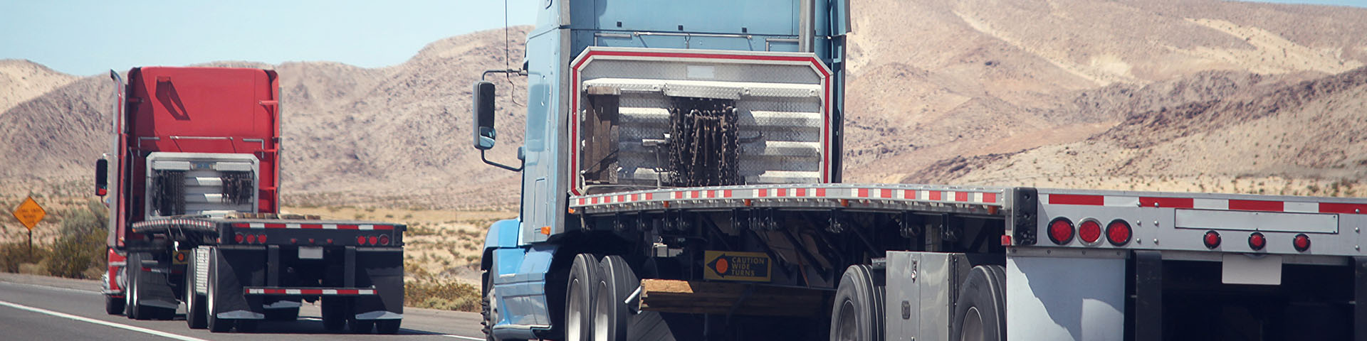 Two Flatbed trucks traveling in the desert - Express Fleet Maintenance - Savannah, GA